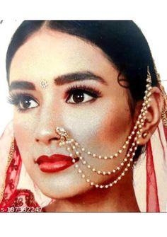 a woman with pearls on her face and nose