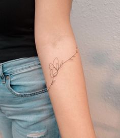 a woman with a small tattoo on her arm