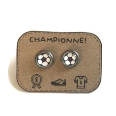 Lovely handmade Soccer stud earrings  attached to a hand designed kraft gift card. Message reads: Championne! PLEASE, NOTE THAT THE STANDARD SHIPPING IS WITHOUT TRACKING (99% safe and reliable). YOU CAN CHOOSE A SHIPPING WITH TRACKING AT CHECKOUT. → MEASUREMENTS: * Earrings:  10mm/ 0.43"i (by default). If you wish another size, the earrings are also available in 8 mm / 0.35"i or 12 mm / 0.51" i . Thanks letting me know when ordering. → MATERIALS: * Shiny Silver finish (stainless steel) * High-qu Soccer Earrings, Soccer Jewelry, Waterproof Paper, Sports Jewelry, Earrings For Girls, Ball Earrings, Girls Earrings, Shiny Silver, Hand Designs