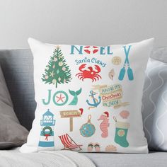 a white pillow sitting on top of a couch next to a gray pillow cover with christmas decorations