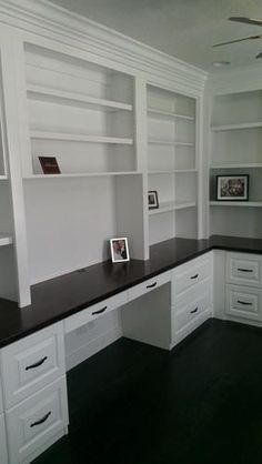 an image of a room with white cabinets and black counter tops on the phone screen