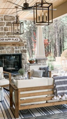 an outdoor living room with furniture and decor on the outside patio, including a fireplace