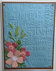 a blue birthday card with flowers and words written on the front, along with an embossed happy birthday message