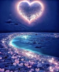 a heart - shaped object floating in the air over an ocean with stars and bubbles