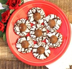 a red plate topped with cookies covered in chocolate