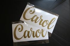 two white and gold stickers that say carol carol on the side of each one