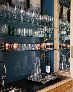 there are many wine glasses on the shelves