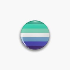 a blue and green striped button on a white background with the colors of the rainbow