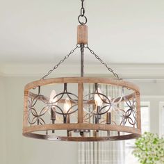 Bring a touch of rustic charm to your home with the 4-light rustic wood cage chandelier. Crafted from beautiful birch wood and metal, this chandelier features five candle-shaped lamp bases suspended from wood and an adjustable chandelier chain extending up to 70 in.. Ideal for both dining and living areas, this chandelier is designed to accommodate sloped ceilings of up to 15 °. While the required bulbs of up to 40 Watts each are not included, the chandelier promises an easy setup. It comes with Rustic Chandelier Farmhouse Entryway, Modern Coastal Chandelier Dining Room, Over Table Chandelier, Farmhouse Entry Light Fixtures, Lake House Lighting Fixtures, Farmhouse Kitchen Lighting Over Table, Farmhouse Dining Room Lighting Over Table, Farmhouse Chandelier Foyer, Farmhouse Light Fixtures Dining Areas