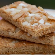 three pieces of food are stacked on top of each other, with white toppings