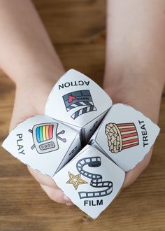 two hands holding four dices with different symbols on them