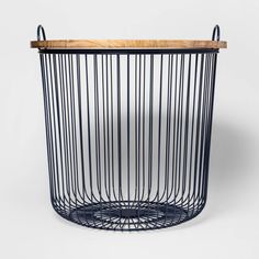 a blue wire basket with wooden top and handles on the bottom, in front of a white background