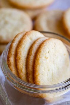 a glass jar filled with cookies on top of a table