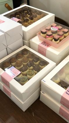 several boxes filled with different types of cupcakes