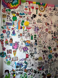 a refrigerator covered in lots of cartoon stickers