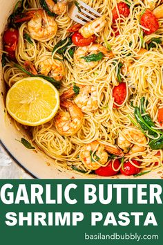 garlic butter shrimp pasta in a skillet with lemon wedges