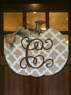 a monogrammed door hanger with the letter g on it