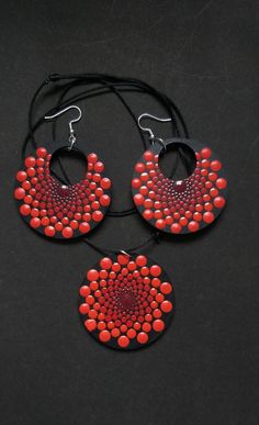 three pieces of red and black beaded jewelry