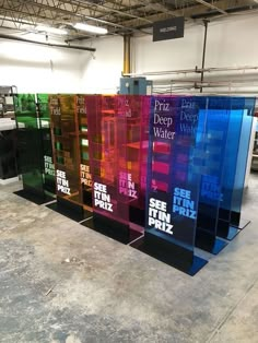 four different colored glass panels in a warehouse with the words prize deep water written on them