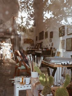 the reflection of an artist's studio in a window