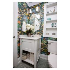 the bathroom is decorated with colorful wallpaper