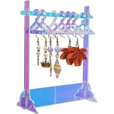 a purple and blue rack with jewelry hanging from it's sides on a white background