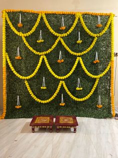 the wall is decorated with yellow flowers and candles for diwaling or decorating