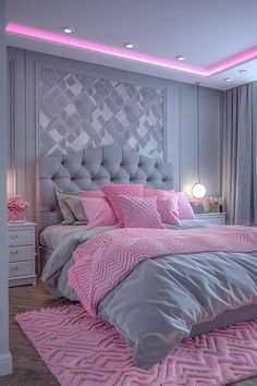 a pink and grey bedroom with a large bed