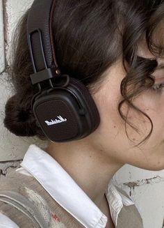 a woman with headphones on her ears