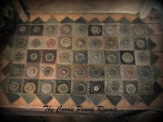 an old quilt is laying on top of a wooden table with the words, the corner penny runner