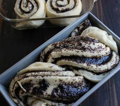 two pans filled with pastries sitting on top of a wooden table