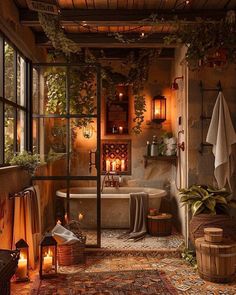 a bath room with a tub a window and candles