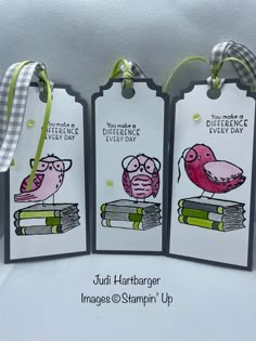 three tags with birds and books on them