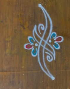 an artistic design painted on the side of a wooden door with white and red designs