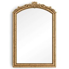 an ornate gold framed mirror on a white wall