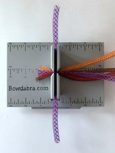 a pair of scissors are on top of a ruler