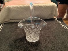 a clear glass basket sitting on top of a rug