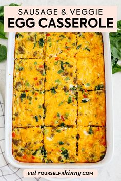 sausage and veggie egg casserole in a baking dish with spinach leaves