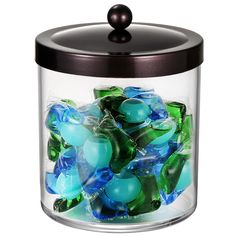 a glass jar filled with lots of blue and green gummy bears