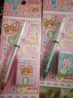 two pens with teddy bears on them sitting next to each other in front of a package