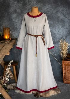 Early Medieval linen underdress gown, dress for the summer. 100% linen. The dress is universal for the Vikings and Slavs or any others reenactors. Based on medieval iconography and archaeological finds from Europe. The dress has 2 gores on both sides. Tapered sleeves, loose and comfortable. The dress is decorated at the round neckline and on the cuffs by the decorative hems (made of linen). The historical pattern is an important element in playing historical realities. The width of the hems is 4 Viking Woman Costume, Germany Clothing, Medieval Germany, Germany Outfits, Medieval Love, Viking Clothes, Celtic Clothing, Wide Dress, Viking Garb