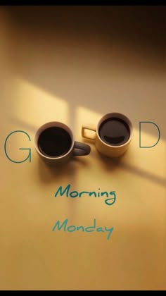 two cups of coffee sitting on top of a table next to the words good morning monday