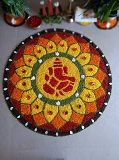 a colorful mat with an image of a hand in the center and flowers around it