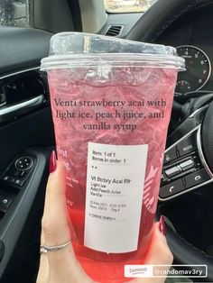 a person holding up a pink drink in their hand with the words, venti strawberry tea with light ice, peach juice and vanilla syrup