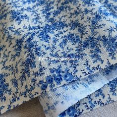 blue and white fabric with small flowers on it's edges, as well as the bottom