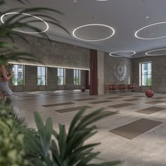 a woman is standing in the middle of a large room