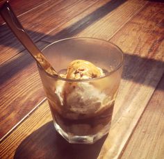 an ice cream sundae in a glass on a wooden table