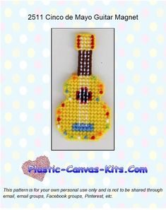 a yellow and black guitar made out of beaded beads on a white background with polka dots