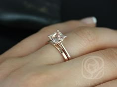 a woman's hand with a ring on it and a diamond in the middle