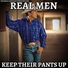 a man wearing a cowboy hat standing next to a wall with the words real men keep their pants up